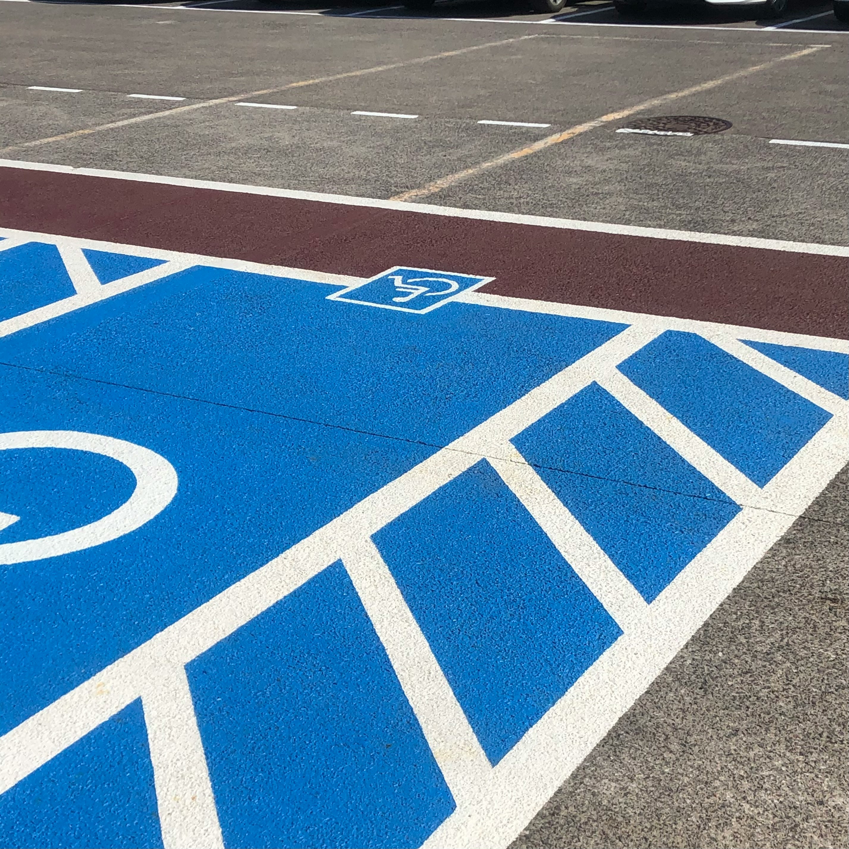 Fresh parking lot striping with clearly marked stalls and traffic lanes
